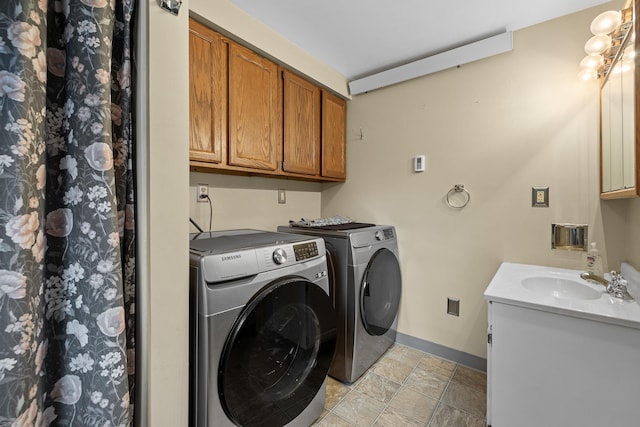 laundry area featuring separate washer and dryer, sink, and light tile floors