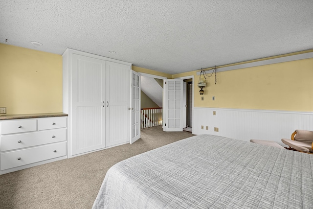 carpeted bedroom with a textured ceiling