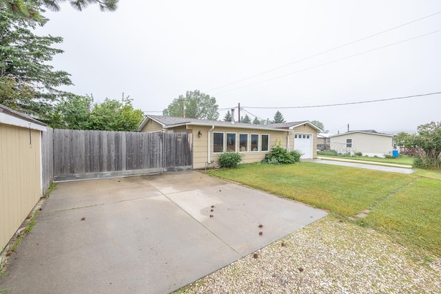 view of front of home featuring a garage and a front lawn