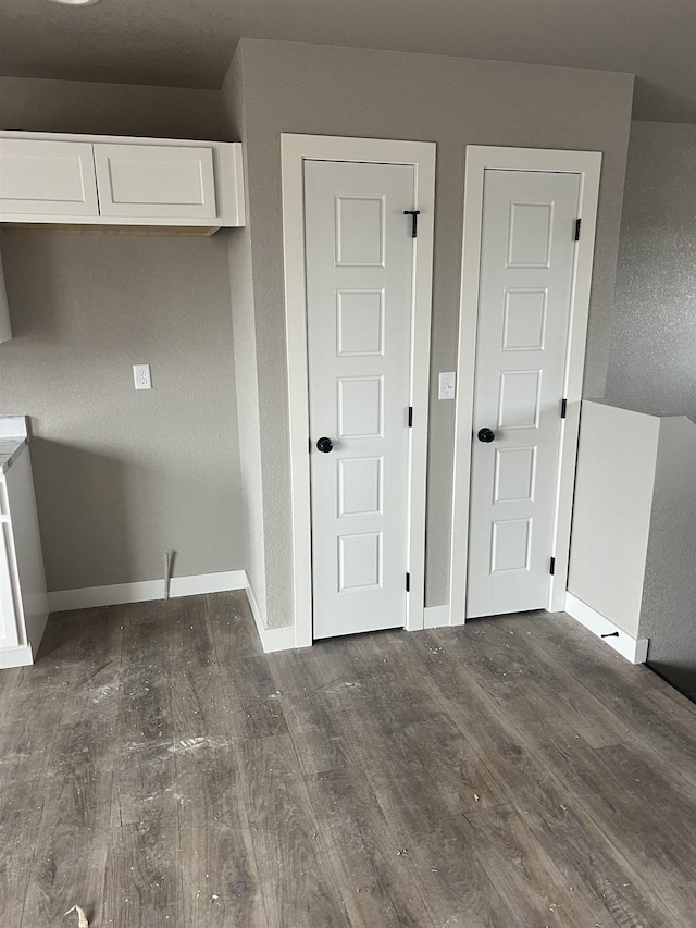 interior space featuring white cabinets and dark hardwood / wood-style floors