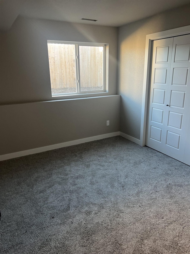 unfurnished bedroom featuring carpet flooring and a closet