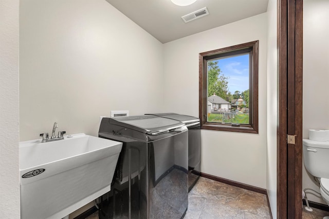 laundry area with washer and dryer and sink