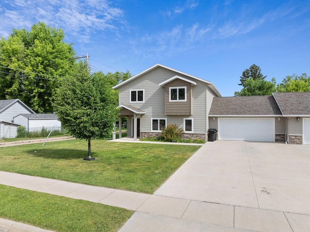 view of front of property with a front yard and a garage