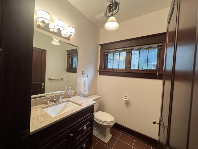 bathroom with tile floors, oversized vanity, and toilet