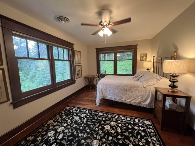 bedroom with ceiling fan and dark hardwood / wood-style floors