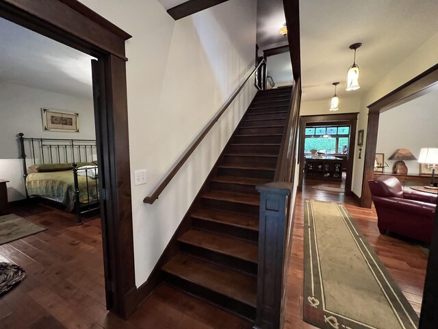 staircase featuring dark hardwood / wood-style flooring