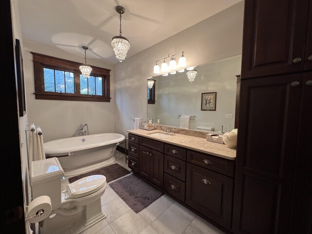 bathroom featuring a chandelier, a bathtub, tile floors, toilet, and vanity