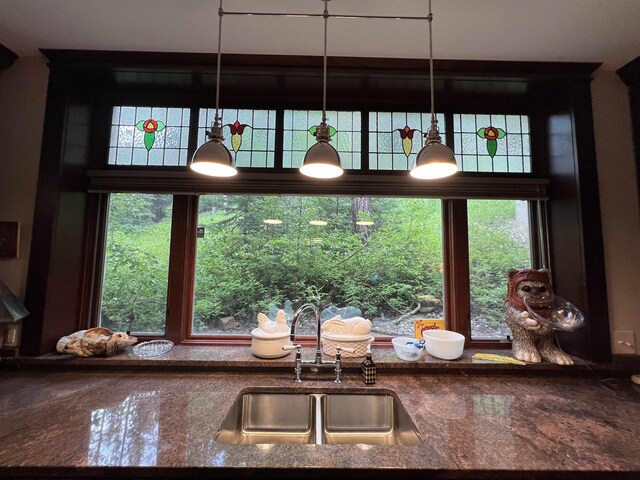 kitchen with sink and dark stone countertops