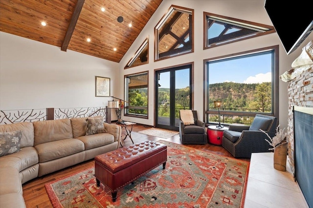 living room featuring beamed ceiling, wooden ceiling, hardwood / wood-style flooring, and high vaulted ceiling