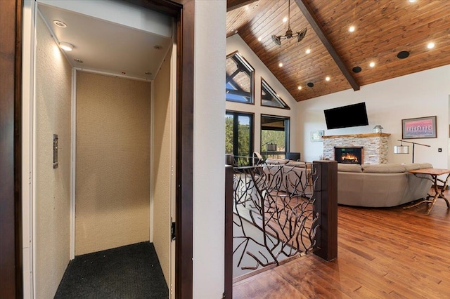 hall featuring beamed ceiling, hardwood / wood-style flooring, high vaulted ceiling, and wood ceiling