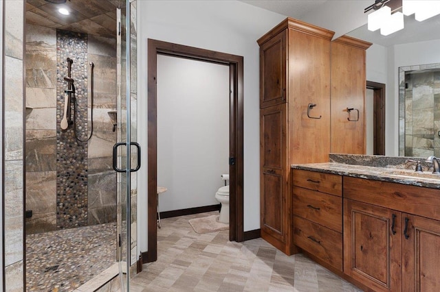 bathroom featuring walk in shower, tile patterned flooring, toilet, and vanity