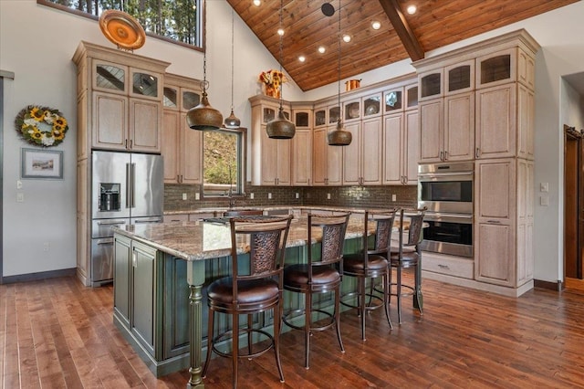 kitchen featuring stainless steel appliances, wooden ceiling, high vaulted ceiling, light stone counters, and a kitchen island