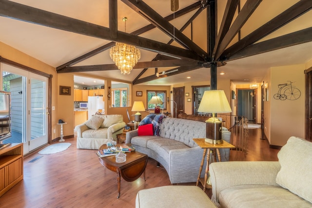 11504 Melchert Pl, Hill City, SD 57745 - living area with baseboards, wood finished floors, a chandelier, and vaulted ceiling with beams