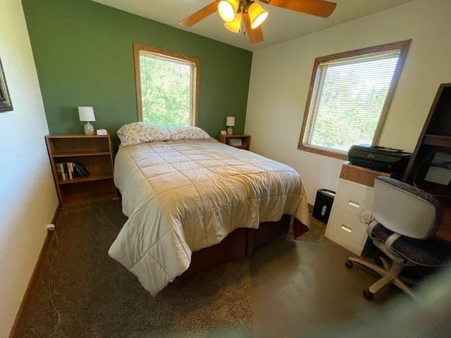 bedroom featuring ceiling fan and multiple windows