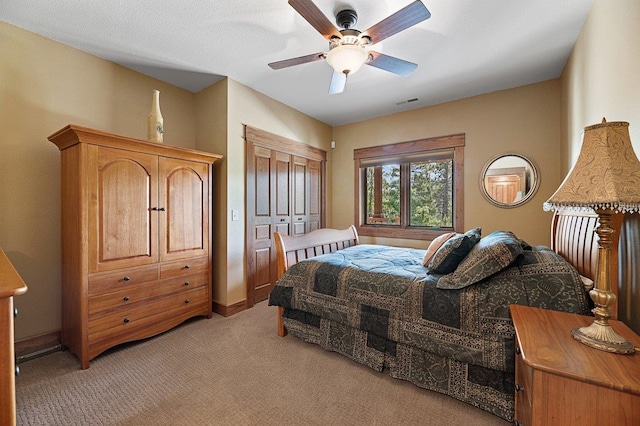 carpeted bedroom featuring a closet and ceiling fan