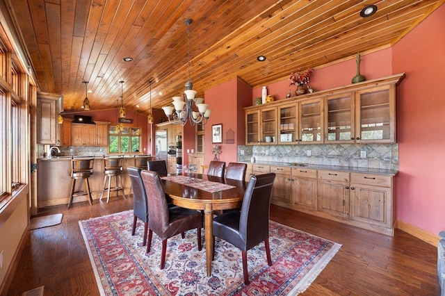 dining area with an inviting chandelier, dark wood-type flooring, wooden ceiling, and vaulted ceiling