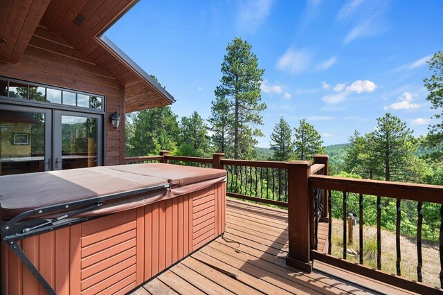 deck featuring a hot tub