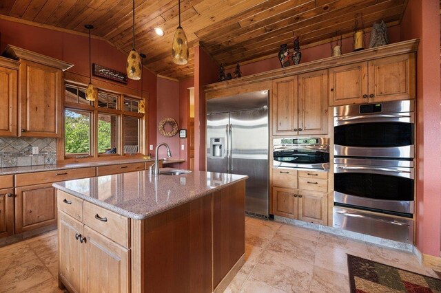 kitchen with wooden ceiling, decorative backsplash, sink, appliances with stainless steel finishes, and a kitchen island with sink