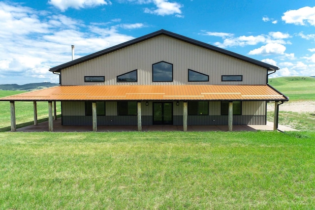 rear view of house featuring an outdoor structure