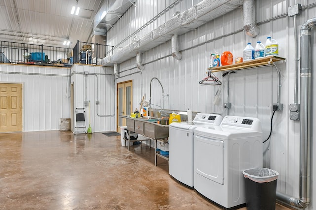 laundry room with separate washer and dryer and a high ceiling