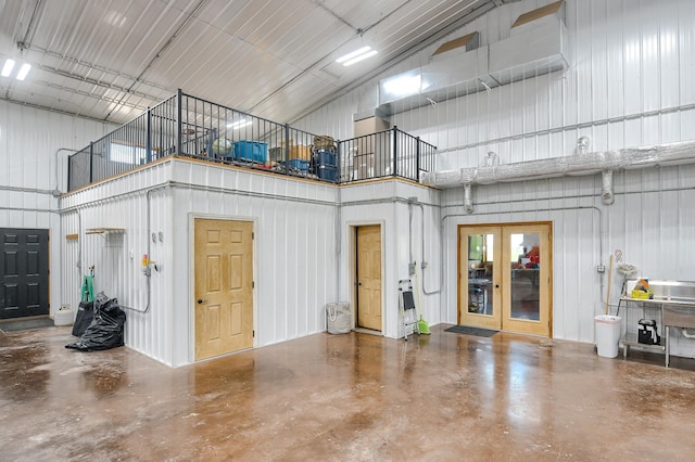 garage with wood walls and french doors