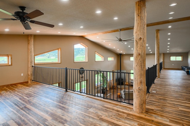 interior space featuring ceiling fan, lofted ceiling, and hardwood / wood-style flooring