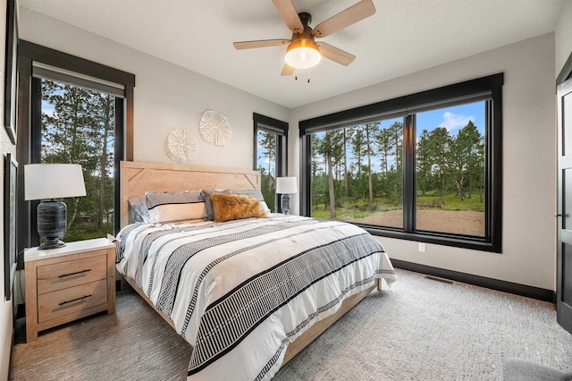 bedroom with multiple windows and ceiling fan