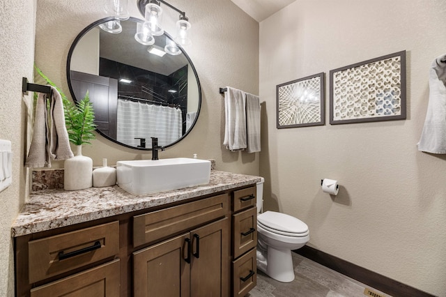 bathroom with vanity, toilet, and hardwood / wood-style floors