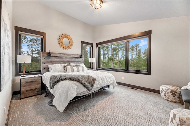 carpeted bedroom featuring vaulted ceiling