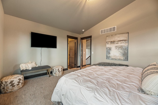 carpeted bedroom featuring vaulted ceiling