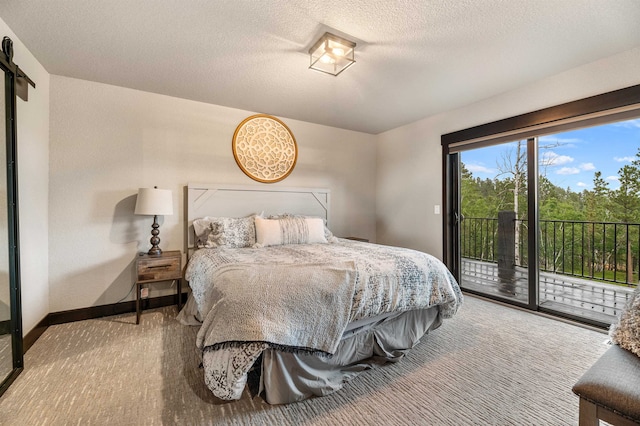 carpeted bedroom featuring access to outside and a textured ceiling