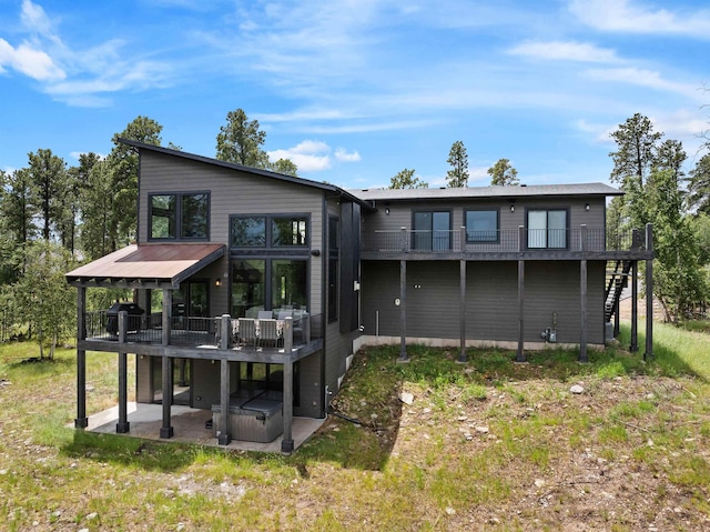 21242 Rubys Way, Lead, SD 57754 - rear view of property featuring a patio area, a deck, and a hot tub