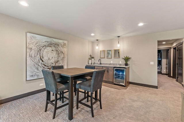 carpeted dining space with sink and wine cooler