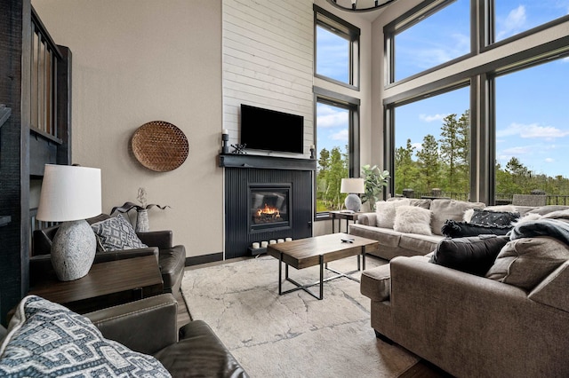 living room featuring a fireplace and a towering ceiling