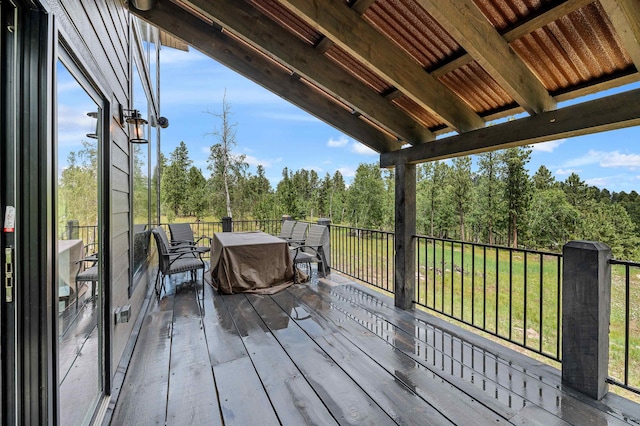 wooden deck featuring a lawn