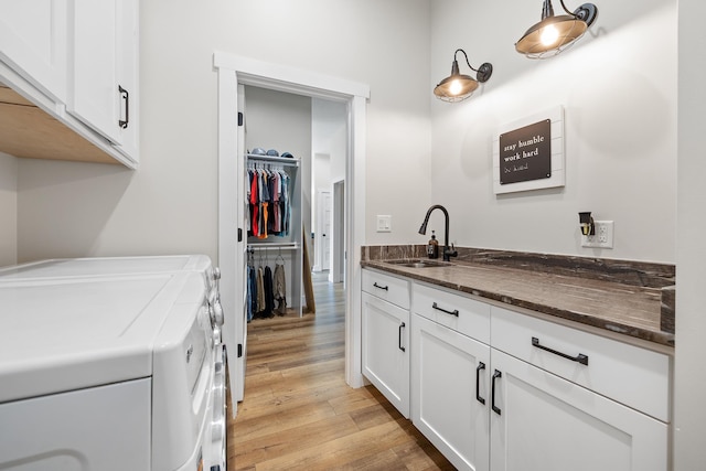 bathroom with vanity, wood-type flooring, and washer and clothes dryer