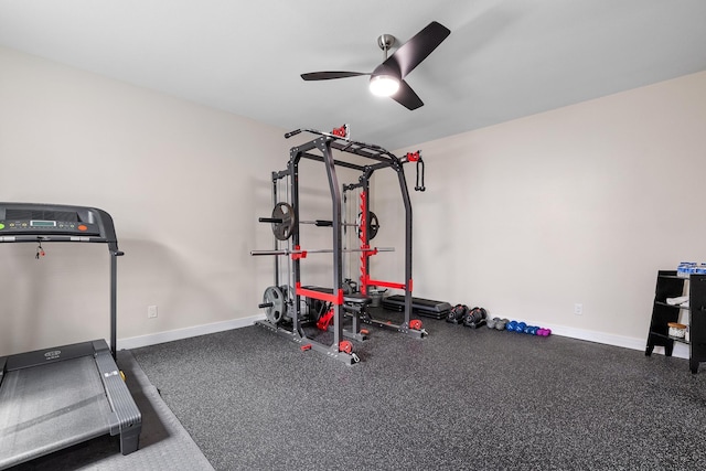 workout area with baseboards and ceiling fan