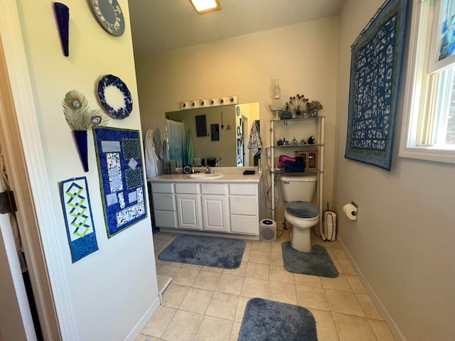 bathroom featuring vanity, toilet, and tile patterned flooring