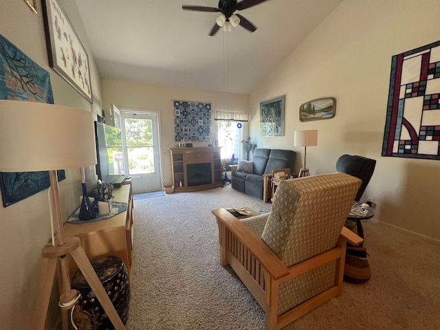 living room with carpet floors, a fireplace, ceiling fan, and lofted ceiling