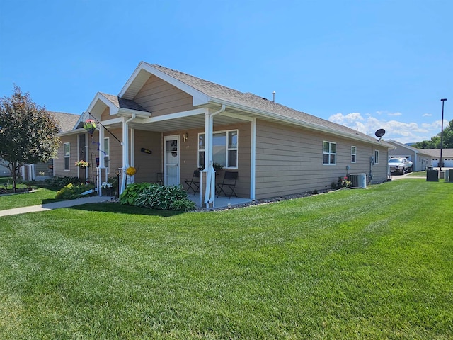 view of home's exterior with central AC and a lawn