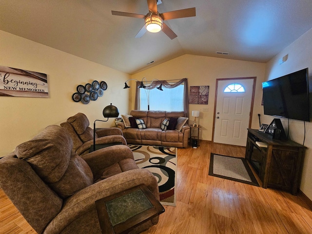 living room featuring wood-type flooring, vaulted ceiling, and ceiling fan