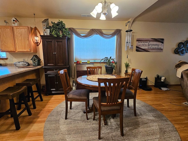 dining room featuring a notable chandelier and light hardwood / wood-style flooring