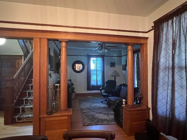 entryway featuring ceiling fan, ornate columns, and hardwood / wood-style floors