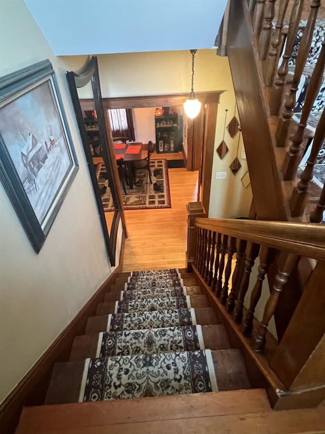 stairs featuring hardwood / wood-style flooring