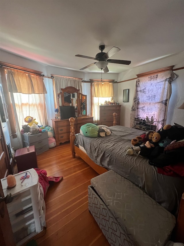 bedroom with ceiling fan and wood-type flooring