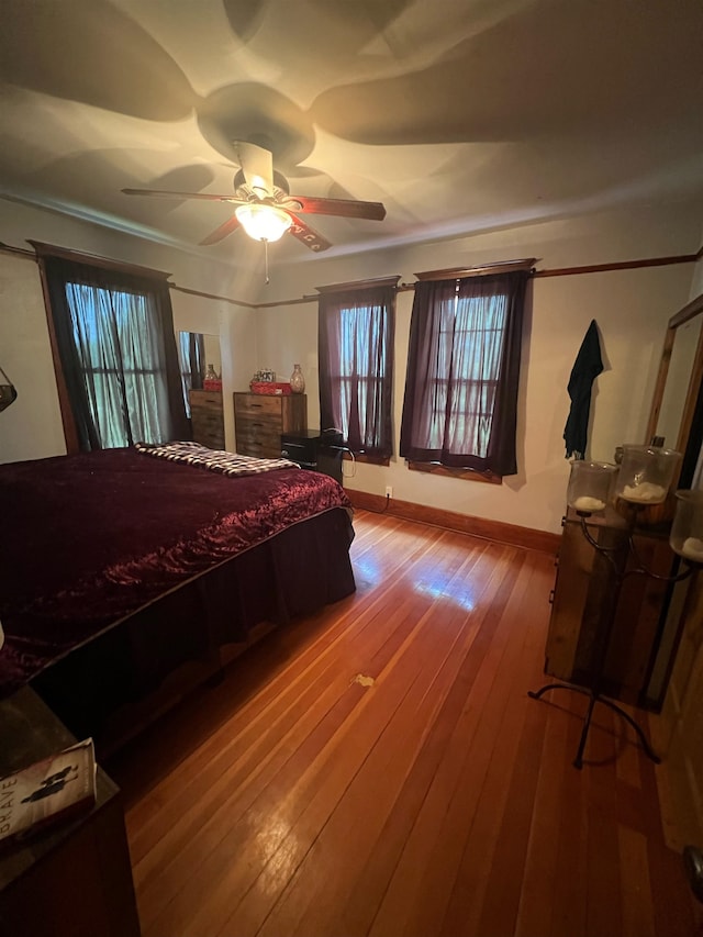 bedroom featuring hardwood / wood-style flooring and ceiling fan