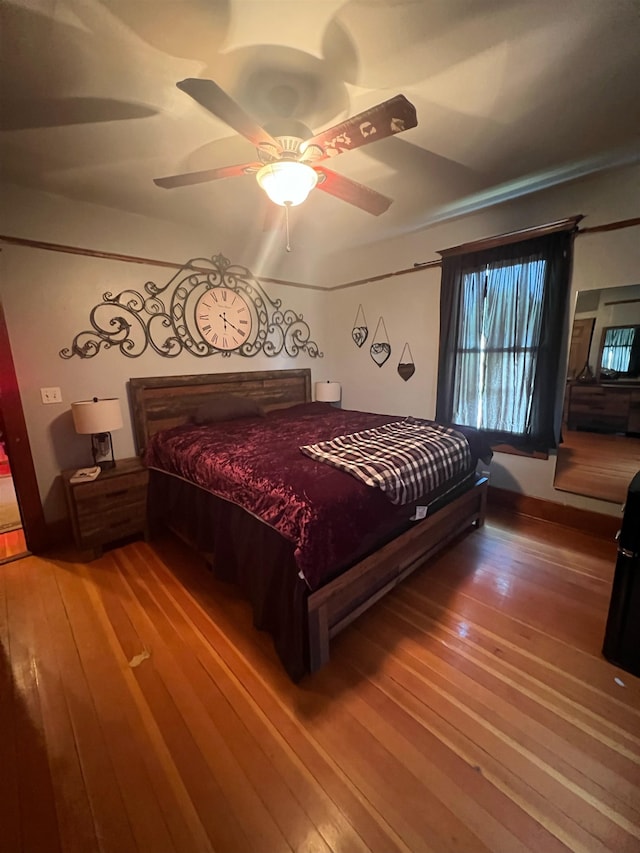 bedroom with ceiling fan and wood-type flooring