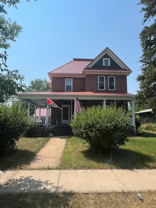 view of front facade with a porch and a front yard