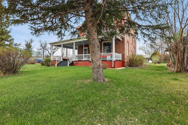 exterior space with brick siding, a lawn, and a porch