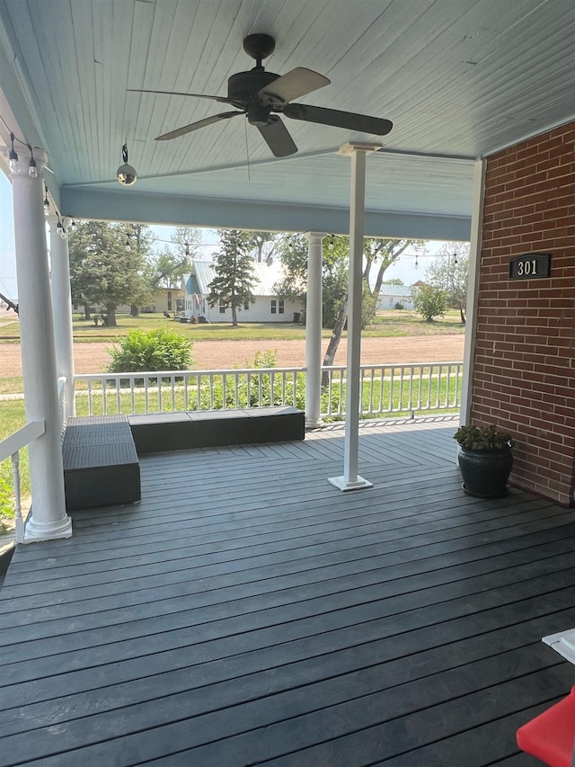 wooden deck featuring ceiling fan